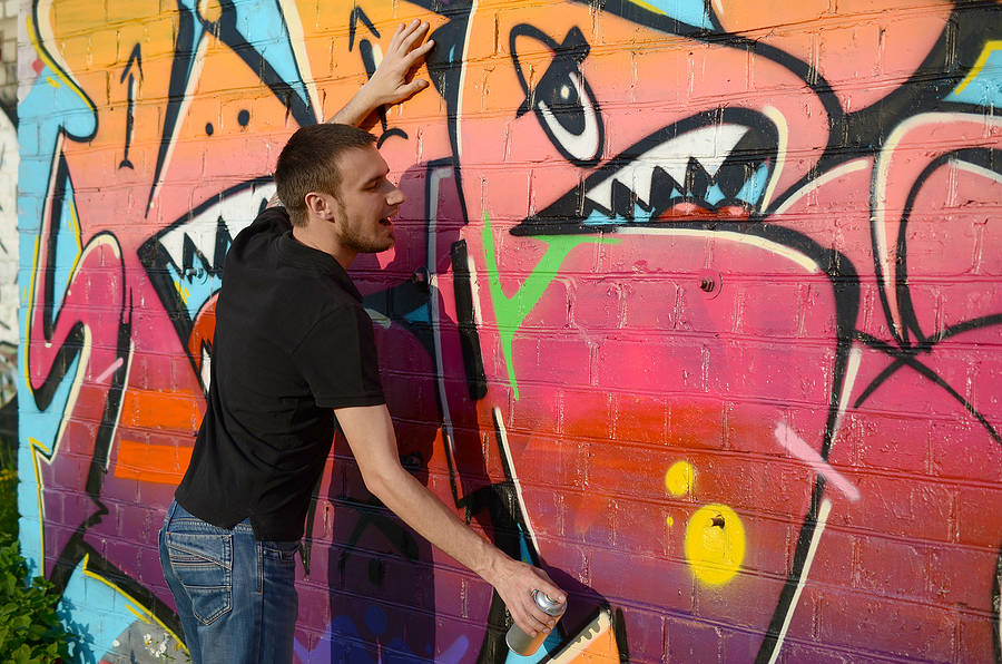 Graffiti being removed from a wall